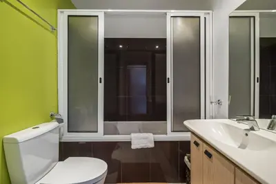 a bathroom with a white toilet and a sink at Canico City Center by Zest and Guest in Santa Cruz