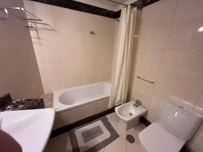 a bathroom with a toilet and a tub and a sink at Apartment Machico near the beach in Machico