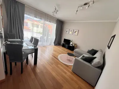 a living room with a table and a couch at Apartment Machico near the beach in Machico