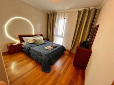 a bedroom with a bed and a large mirror at Apartment Machico near the beach in Machico