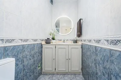 a bathroom with a sink and a mirror at Du.Val - Madeira Valley Villa in Ribeira Brava