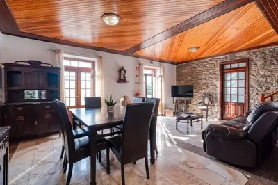 a dining room with a wooden ceiling and a table and chairs at Casa Lucas by Stay Madeira in Ponta do Sol