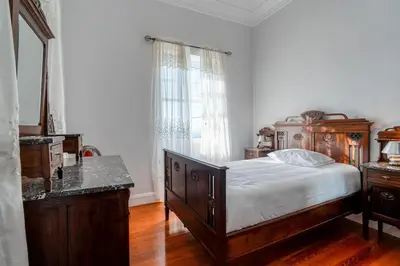 a bedroom with a wooden bed and a window at Casa Lucas by Stay Madeira in Ponta do Sol
