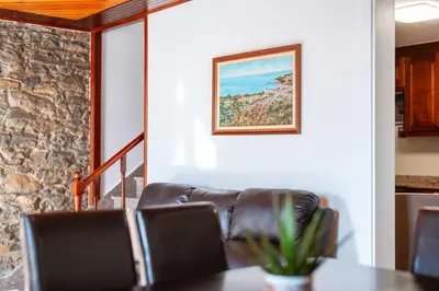 a dining room with a table and a couch at Casa Lucas by Stay Madeira in Ponta do Sol