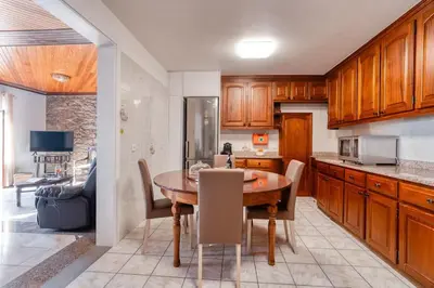 a kitchen with a wooden table and a dining room at Casa Lucas by Stay Madeira in Ponta do Sol