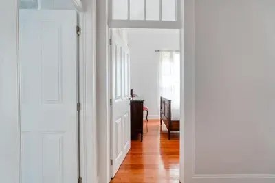 a hallway with a door and a room with a table at Casa Lucas by Stay Madeira in Ponta do Sol