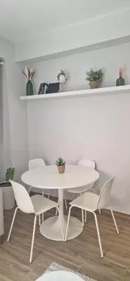 a white dining room with a white table and chairs at Machico Heart Suites in Machico