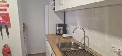 a kitchen with a sink and a counter with a sink at Machico Heart Suites in Machico
