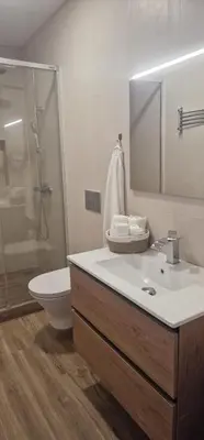 a bathroom with a sink and a shower and a toilet at Machico Heart Suites in Machico