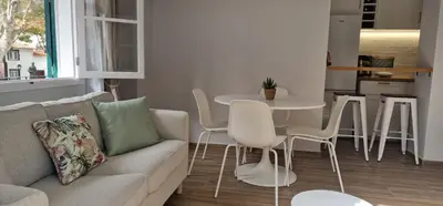 a living room with a couch and a table and chairs at Machico Heart Suites in Machico