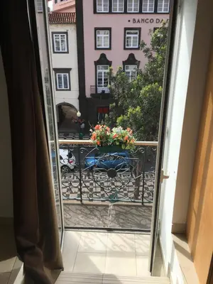 a bedroom with a bed and a window at Esmeralda Holidays Apartments in Funchal