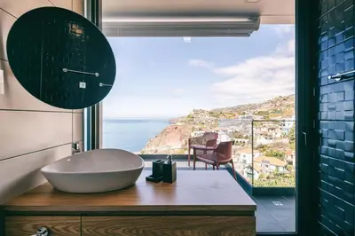 a bathroom with a sink and a view of the ocean at Villa Ocean Haven by AH in Ribeira Brava