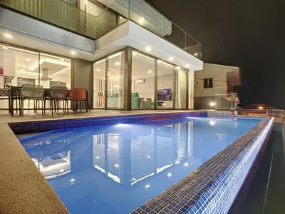 a swimming pool in front of a house at Villa Ocean Haven by AH in Ribeira Brava