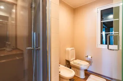 a small bathroom with a toilet and a shower at GuestReady - Madeiran paradise with ocean view in Funchal