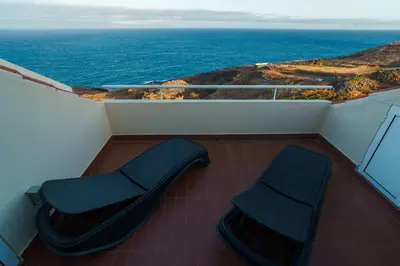 a balcony with two chairs and a view of the ocean at GuestReady - Madeiran paradise with ocean view in Funchal