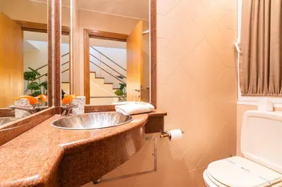 a bathroom with a sink and a toilet and a mirror at GuestReady - Madeiran paradise with ocean view in Funchal