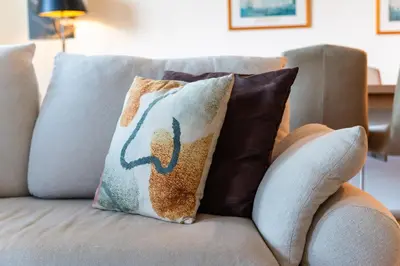 a couch with two pillows on it at GuestReady - Madeiran paradise with ocean view in Funchal