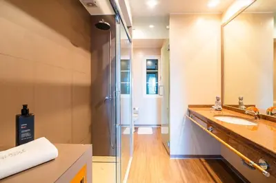 a bathroom with a glass shower and a sink at GuestReady - Madeiran paradise with ocean view in Funchal