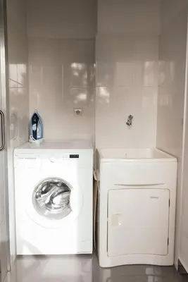 a laundry room with a washing machine and a sink at Luxurious Lido-Sun Island X1V Apt.Free parking in Funchal