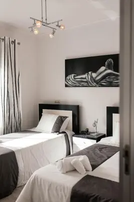a bedroom with two beds and a table at Luxurious Lido-Sun Island X1V Apt.Free parking in Funchal