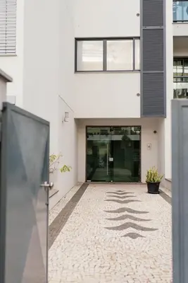 an empty hallway of a white building with a courtyard at Luxurious Lido-Sun Island X1V Apt.Free parking in Funchal