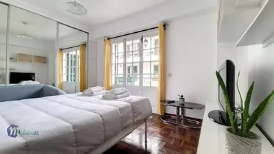 a bedroom with a bed and a large window at Linda´s Studio in Funchal