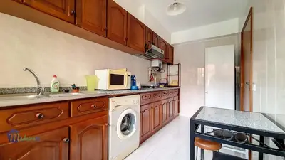 a kitchen with a washing machine and a microwave at Linda´s Studio in Funchal