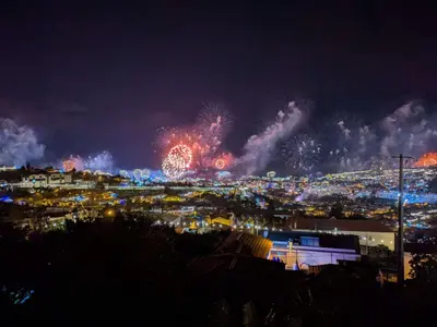 a city with fireworks in the sky at night at Alojamento Funchal - Silvestre House in Funchal