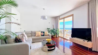 a living room with a couch and a flat screen tv at Glorious Apartment by LovelyStay in Funchal