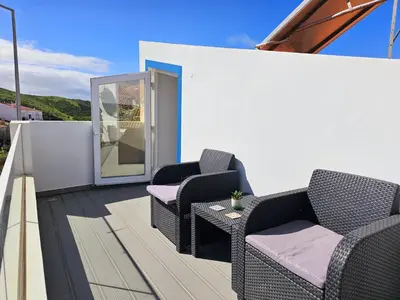 a patio with two chairs and a table at Casa D´Aldeia - Carrapateira in Aljezur