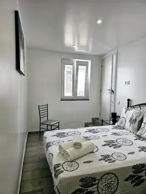 a bedroom with a bed with a towel on it at Casa D´Aldeia - Carrapateira in Aljezur
