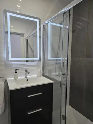 a bathroom with a sink and a shower with a mirror at Casa D´Aldeia - Carrapateira in Aljezur