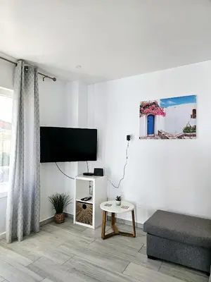 a living room with a couch and a flat screen tv at Casa D´Aldeia - Carrapateira in Aljezur