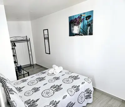 a white room with a bed with a blanket at Casa D´Aldeia - Carrapateira in Aljezur