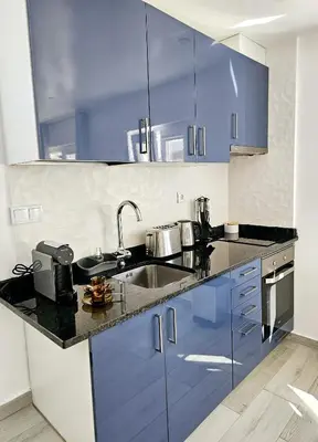 a kitchen with blue cabinets and a sink at Casa D´Aldeia - Carrapateira in Aljezur