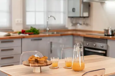 a kitchen with a table with two glasses of orange juice at Santa Cruz I by An Island Apart in Santa Cruz