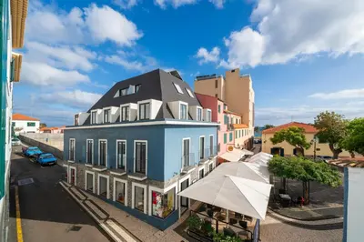 a blue building with a black roof on a street at Santa Cruz I by An Island Apart in Santa Cruz