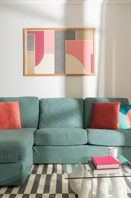 a green couch in a living room with a table at Santa Cruz I by An Island Apart in Santa Cruz