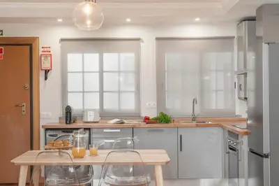 a kitchen with a table and chairs in it at Santa Cruz I by An Island Apart in Santa Cruz