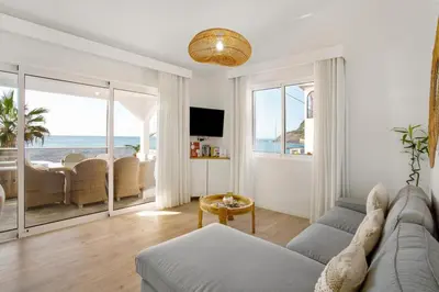a living room with a couch and a view of the ocean at Sunset house in Paul do Mar