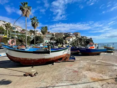a group of boats sitting on the beach at Sunset house in Paul do Mar