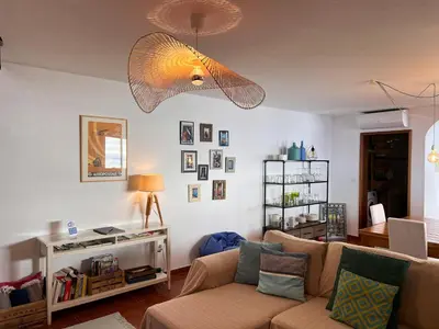 a living room with a couch and a lamp at Casa da Ovelha I Madeira in Fajã da Ovelha