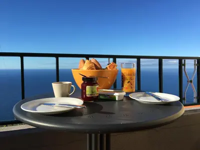 a table with plates of food and a bowl of bread at Casa da Ovelha I Madeira in Fajã da Ovelha