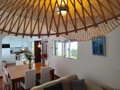 a dining room and kitchen with a table and chairs at Casa da Ovelha I Madeira in Fajã da Ovelha
