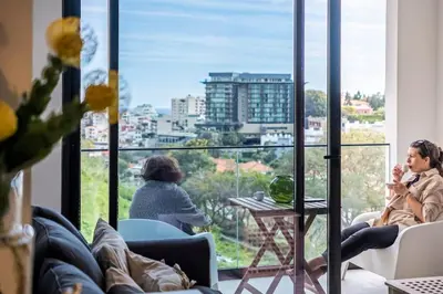 two women sitting in chairs in front of a window at CENTRAL LOCATION - WITH POOL in Funchal