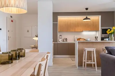 a kitchen and living room with a table and chairs at CENTRAL LOCATION - WITH POOL in Funchal