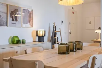 a dining room with a wooden table with a lamp at CENTRAL LOCATION - WITH POOL in Funchal