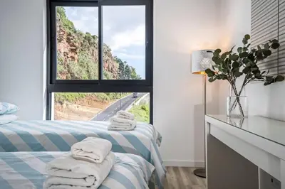 a room with two beds and a window with towels at CENTRAL LOCATION - WITH POOL in Funchal