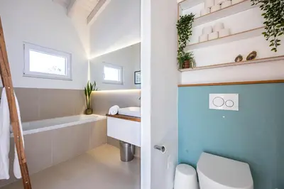 a bathroom with a toilet and a sink and a bath tub at Villa Natureza in Aljezur
