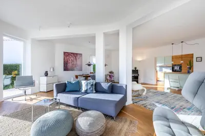 a living room with a blue couch and a table at Villa Natureza in Aljezur